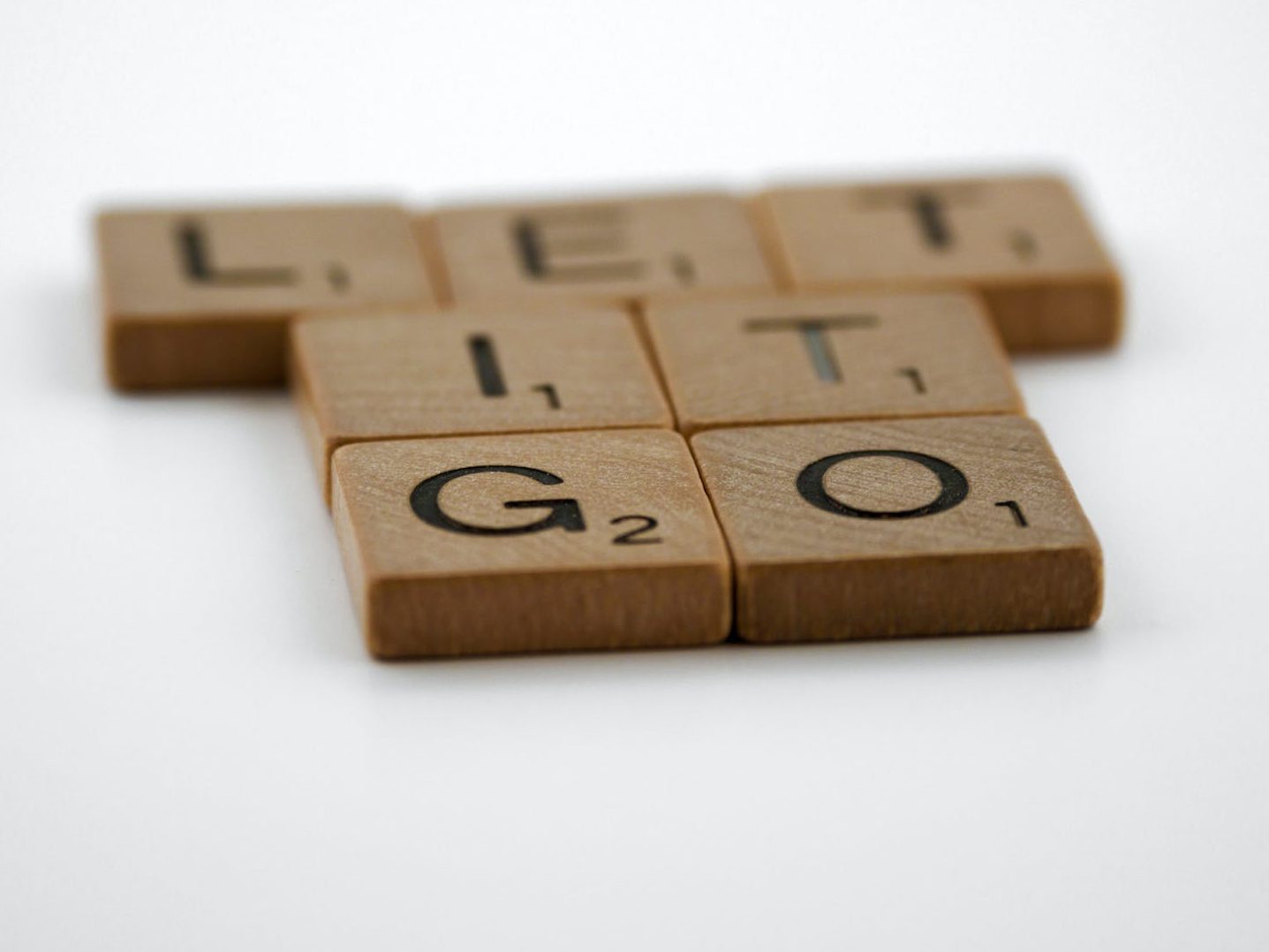 scrabble tiles on a white surface